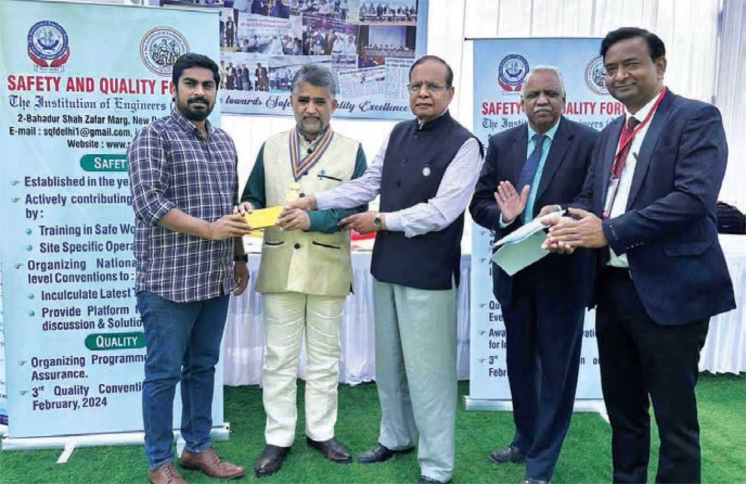 Dr G Ranganathan, President IEI, giving award with Er. J C Singhal, Council Member, Er. G Kumawat, SQF, and Chairman Jharkhand Centre, to Safety Quiz winner at 38th Indian Engineering Congress on 28th December 2023, at Jabalpur, MP.